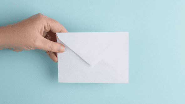 person holding mail letter